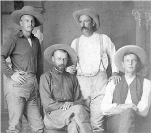 Four cowboys posed for a photograph