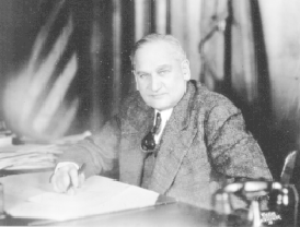 William Langer seated at his desk