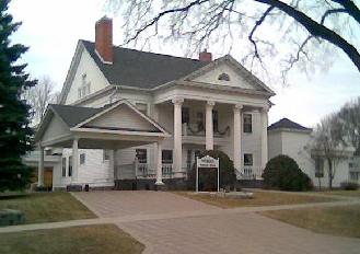 The Lyon Home around 1906 with a horse-drawn carriage
